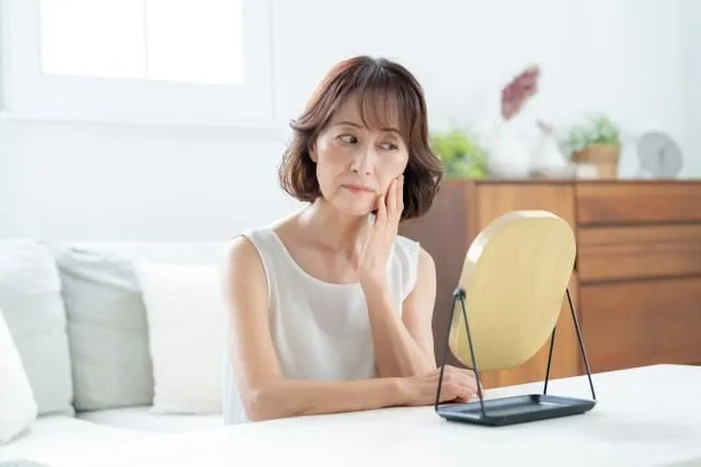 シミやシワをフェイシャルサロンで施術しようか考えている50代女性